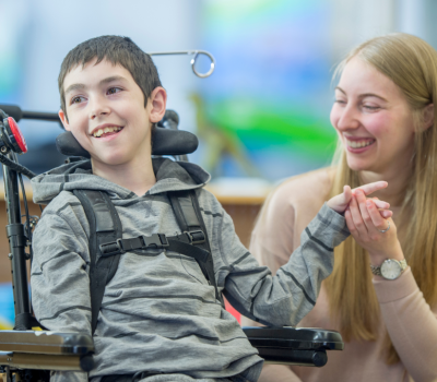 A student and teacher at a library with reading books for send pupils