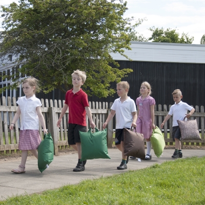 Children carrying nature grab & go cushions